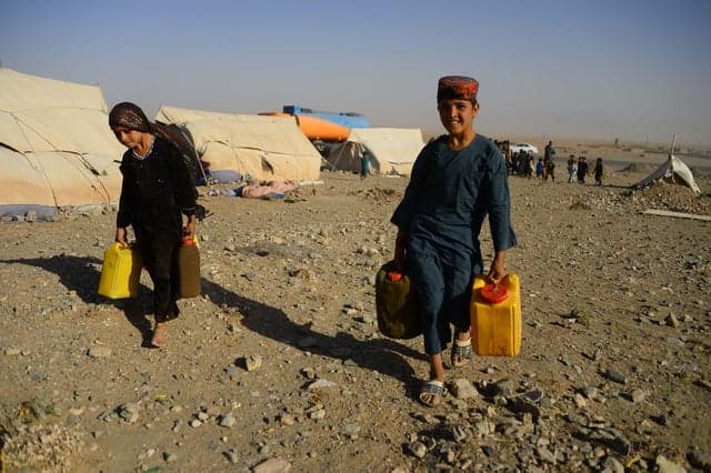 People carrying water in rural Afghanistan